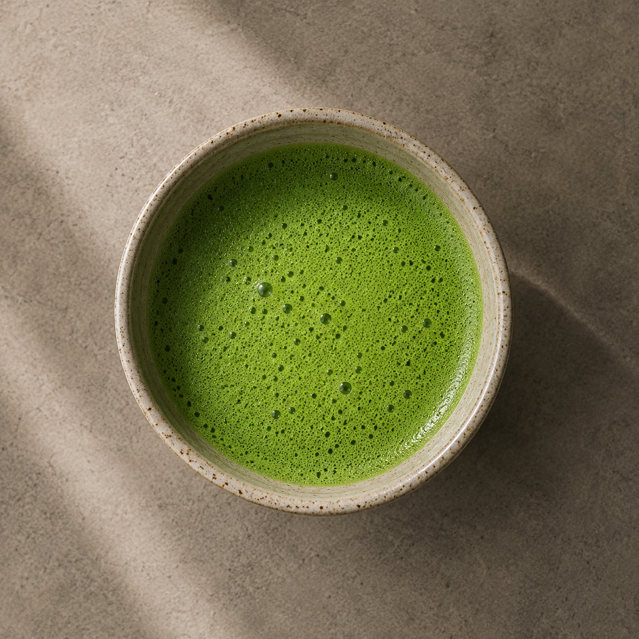 Freshly whisked Japanese Ceremonial Grade Matcha in a ceramic bowl